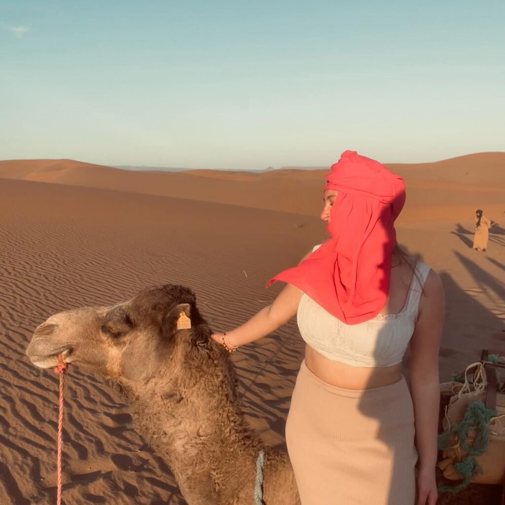 Traveller with a camel in the Sahara dunes near Merzouga